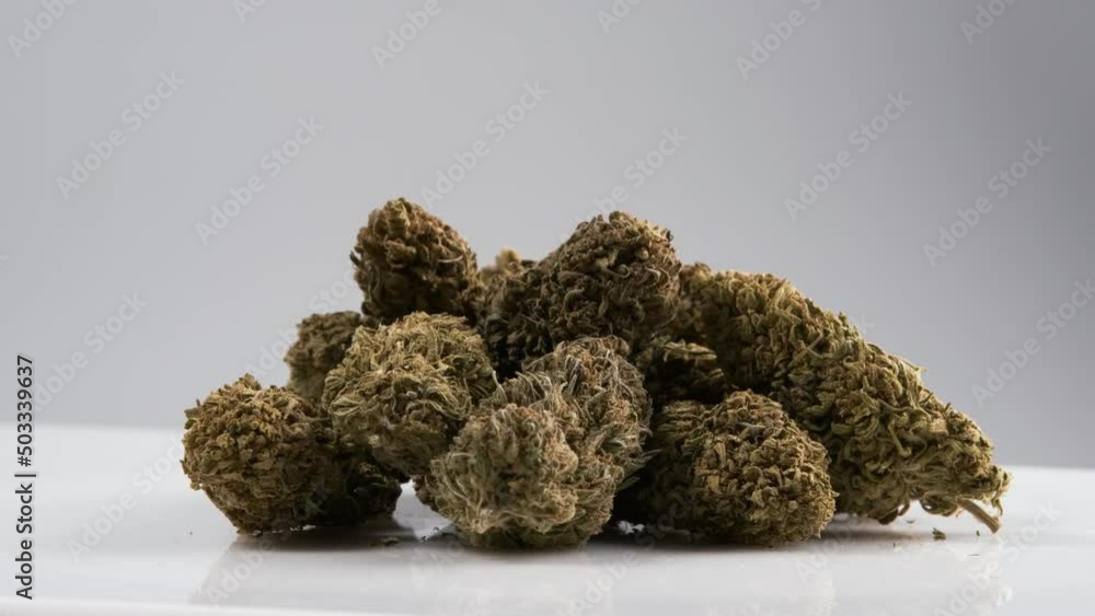 Many Marijuana CBD buds rotating on a white background Many Marijuana CBD buds rotating on a white background