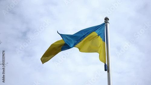 The flag of Ukraine flutters in the wind against the sky