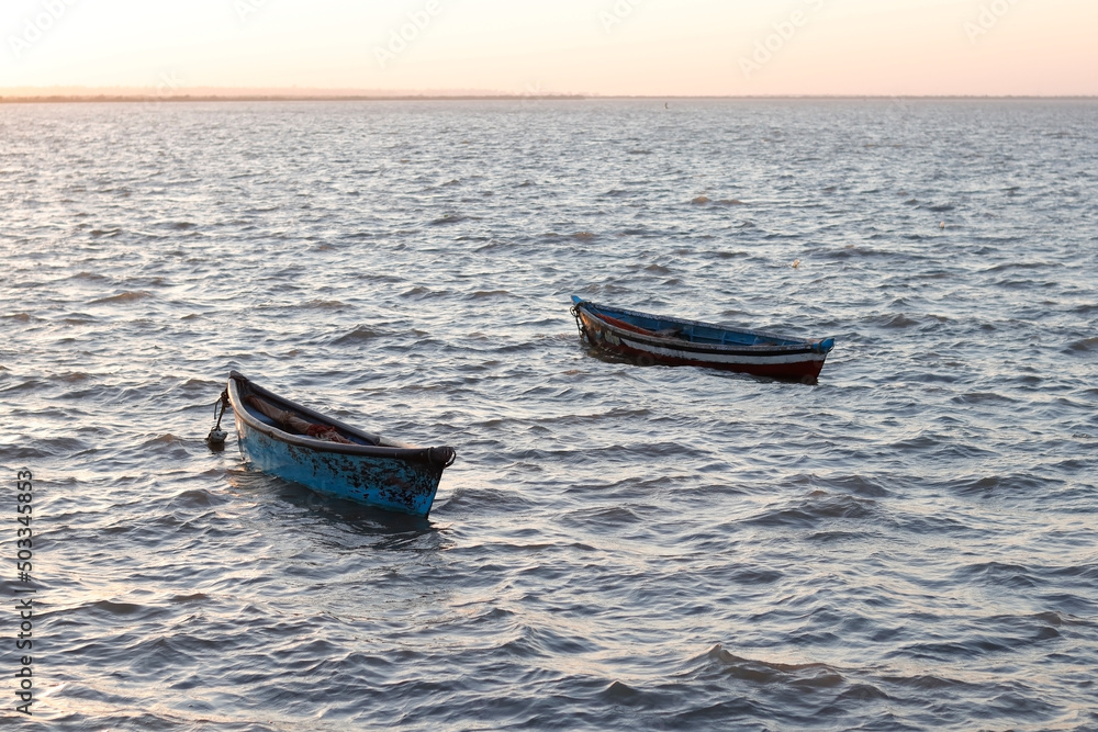 Beautiful landscape of Fishing boats on the sea. two boats and very small boats for fishing. located in Diu district of Union Territory Daman and Diu, India