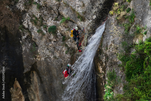 two people waterfall rappelling on canyoning adventure