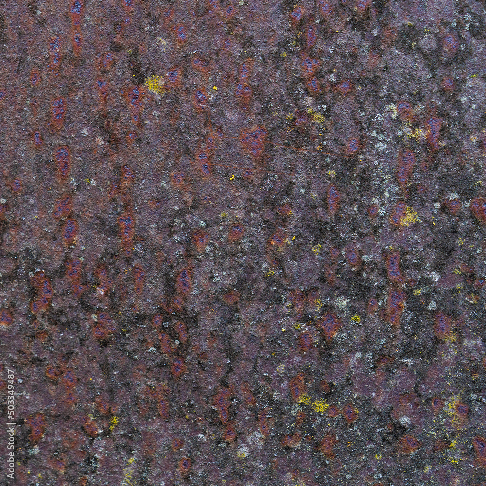 Painted iron surface with a large rusty, black spot and metal corrosion. Old background with peeling and cracking paint. Painted iron surface with a large rusty, black spot and metal corrosion. Old background with peeling and cracking paint.