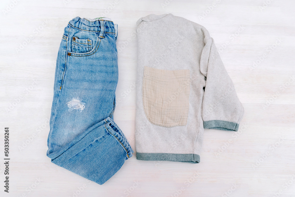 Jumper and jeans pants. Set of baby children's clothes and accessories for spring, autumn or summer on white background. Fashion kids outfit. Flat lay, top view, overhead