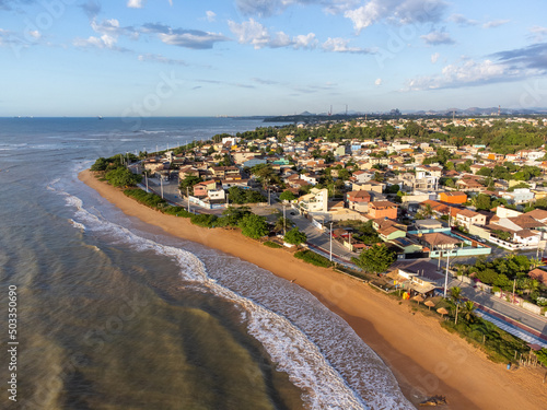 beautiful seaside city of Brazil with dark sand and sunrise on the atlantic ocean - Bicanga, Espirito Santo - aerial drone view