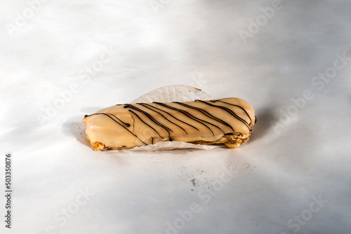 Eclair dessert with nes cream isolated on white paper background. photo