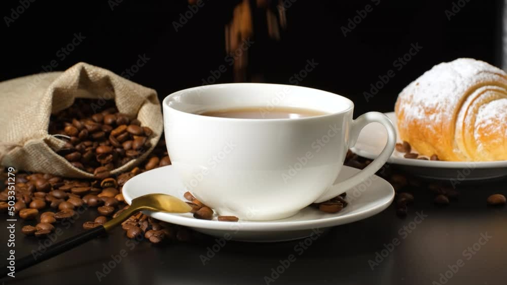 A white cup of coffee and croissant A white cup of coffee and croissant