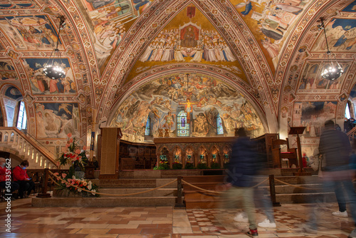 Assisi Italy 2022Faithful visiting the lower basilica of San Francesco d'Assisi, beautifully frescoed by some of the greatest artists of the Italian fourteenth century