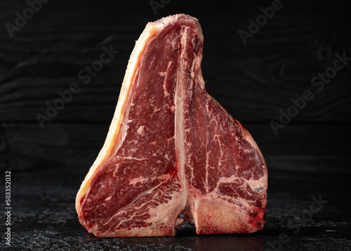 Tablou canvas Raw T Bone beef steak with herb and seasoning on rustic background