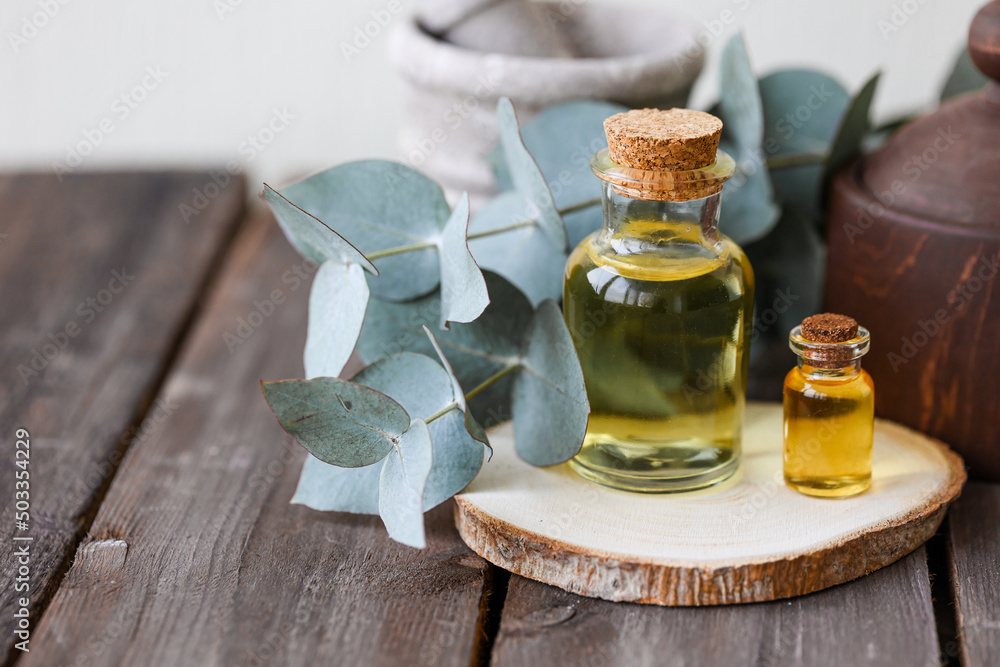 Assortment of natural oils in glass bottles on wooden background. Concept of pure organic ingredients in cosmetology. Bath accessoiries, atmosphere of harmony, relax. Close up macro. Healthy lifestyle Assortment of natural oils in glass bottles on wooden background. Concept of pure organic ingredients in cosmetology. Bath accessoiries, atmosphere of harmony, relax. Close up macro. Healthy lifestyle