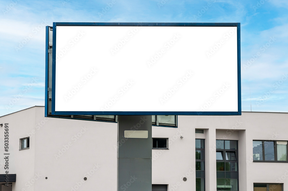 Blank white billboard for advertisement in front of the building. Industrial area. Blank white billboard for advertisement in front of the building. Industrial area.