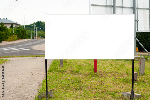 Blank white advertising billboard near the city street