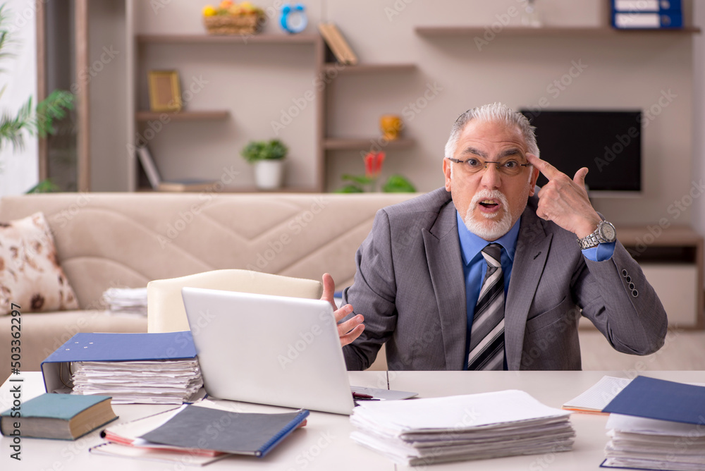 Fototapeta premium Old male employee working from home during pandemic