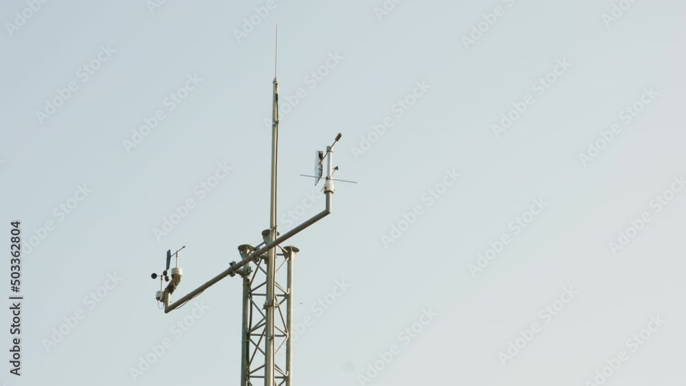 Meteo station works on forecasting weather with special antennas against cloudless sky. Antennas work collecting data on high structure of weather station. Meteo station works on forecasting weather with special antennas against cloudless sky. Antennas work collecting data on high structure of weather station.