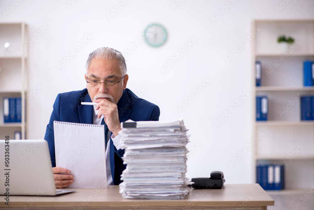 Old male employee and too much work in the office Old male employee and too much work in the office