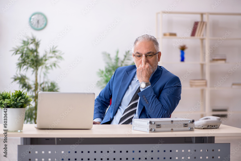 Old male employee in remuneration concept Old male employee in remuneration concept