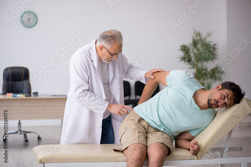 Young male patient visiting old male doctor