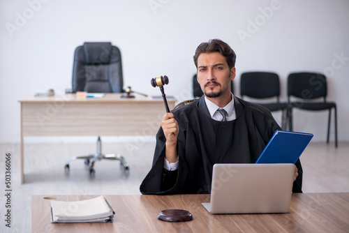 Fotografía Young male judge working in the courthouse