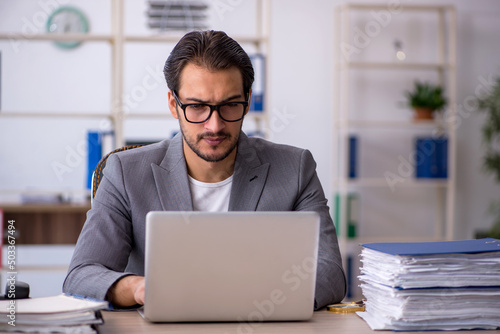 Young male employee working in the office