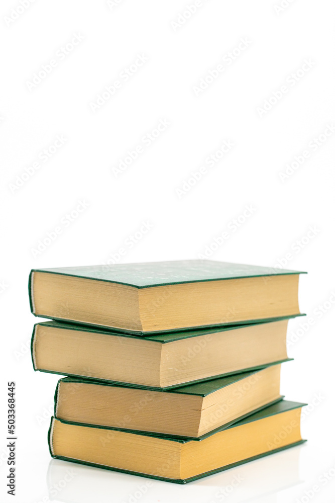 Literature and reading concept. Books stack with green covers on a white background.Reading of books. Knowledge concept.Reading and education. Literature and reading concept. Books stack with green covers on a white background.Reading of books. Knowledge concept.Reading and education.