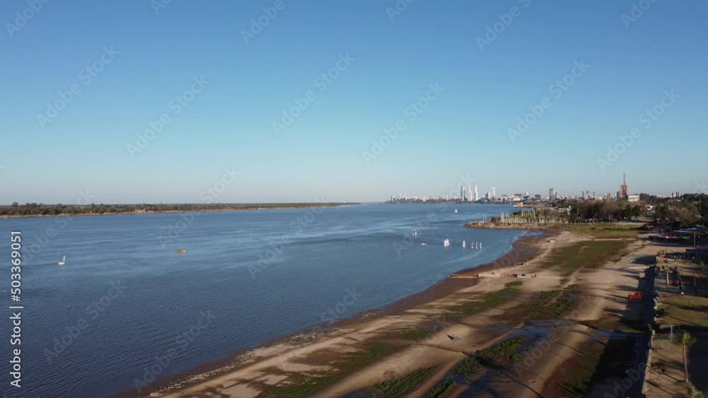 Beautiful sunset of boats along the river with the city in the background under a blue sky Beautiful sunset of boats along the river with the city in the background under a blue sky