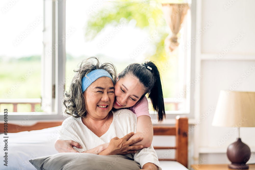 Portrait of enjoy happy love asian family senior mature mother and young woman daughter smiling laughing embracing and having fun hug together.happy family in moments good time at home Portrait of enjoy happy love asian family senior mature mother and young woman daughter smiling laughing embracing and having fun hug together.happy family in moments good time at home
