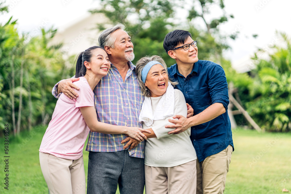 Portrait enjoy happy smiling love multi-generation asian big hug family.Senior mature father and elderly mother with young adult woman and son outdoor in park at home.insurance concept Portrait enjoy happy smiling love multi-generation asian big hug family.Senior mature father and elderly mother with young adult woman and son outdoor in park at home.insurance concept