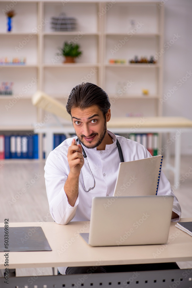 Young male doctor working in the clinic Young male doctor working in the clinic