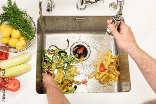 Fotografie Food waste after peeling vegetables is destroyed using the Disposer
