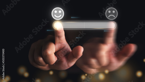 Evaluation and satisfaction concept. Finger of hand slides an emoji face from bad to excellent. These show an improvement of job. Close up shot with gold bokeh glitter on black background.