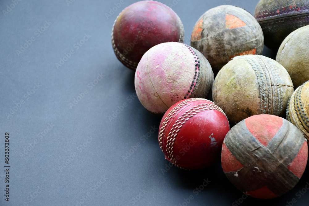 Old and used cricket balls on dark background used for cricket practice, soft and selective focus. Old and used cricket balls on dark background used for cricket practice, soft and selective focus.
