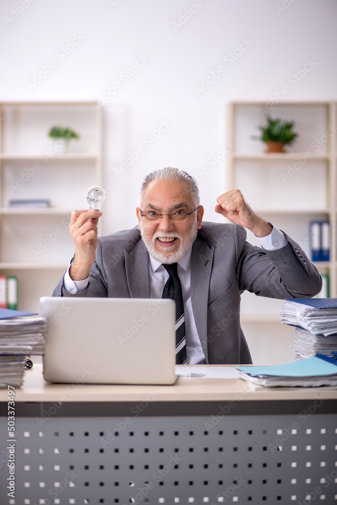 Old male employee in happy idea concept Old male employee in happy idea concept