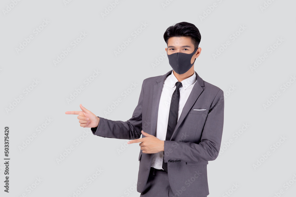 Portrait young asian businessman in suit wearing face mask for protective covid-19 isolated on white background, business man presenting and showing, quarantine for pandemic coronavirus, new normal. Portrait young asian businessman in suit wearing face mask for protective covid-19 isolated on white background, business man presenting and showing, quarantine for pandemic coronavirus, new normal.