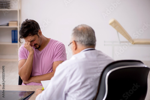 Young male patient visiting old male doctor