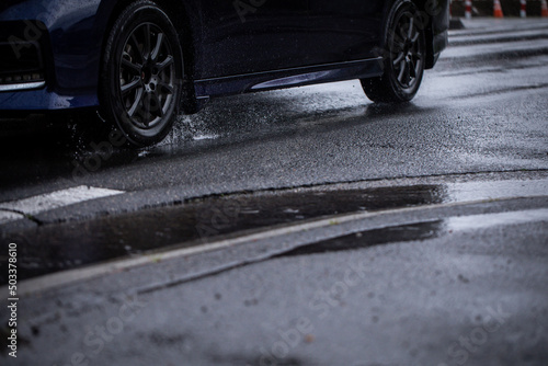 雨の道を走る車 A car running on a rainy road