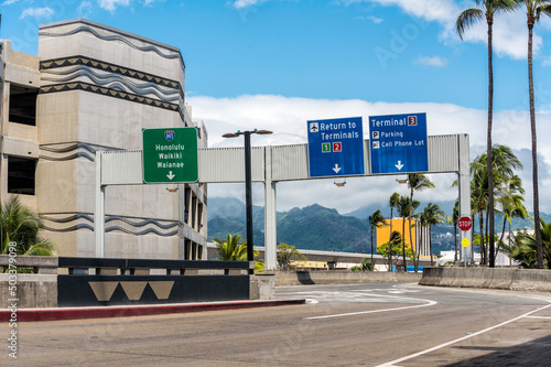 Road signs above the road on International Airport in Honolulu, Hawaii photo