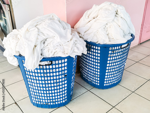 Photo of plastic baskets with dirty laundry.