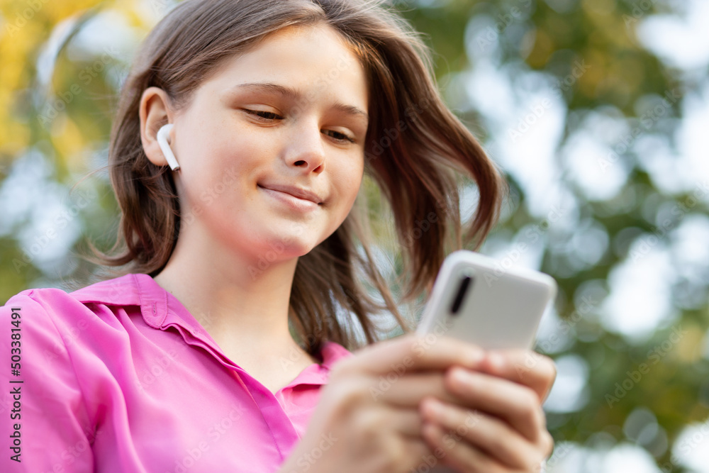 Overjoyed pretty girl wears in pink get carry away with music. Asian teenager girl use smartphone and enjoy favorite playlist via stereo headphones, relaxed sings along with carefree expression. High Overjoyed pretty girl wears in pink get carry away with music. Asian teenager girl use smartphone and enjoy favorite playlist via stereo headphones, relaxed sings along with carefree expression. High
