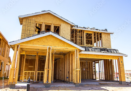 New Multi Story Home Under Construction With Roofing Tile