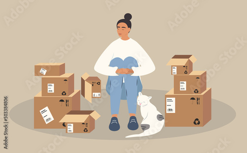 vector illustration in a flat style on the theme of moving. the girl sitting on the floor next to it there are a lot of unpacked boxes and cat