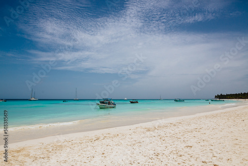 Calm beautiful turquoise sea with boats and white sand beach. Tropical landscape 