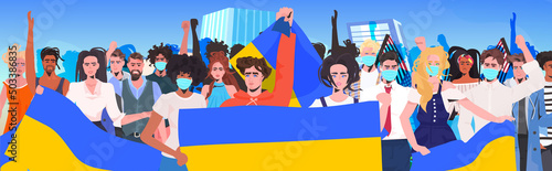 protesters holding Ukrainian flag pray for Ukraine peace save Ukraine from russia stop war concept
