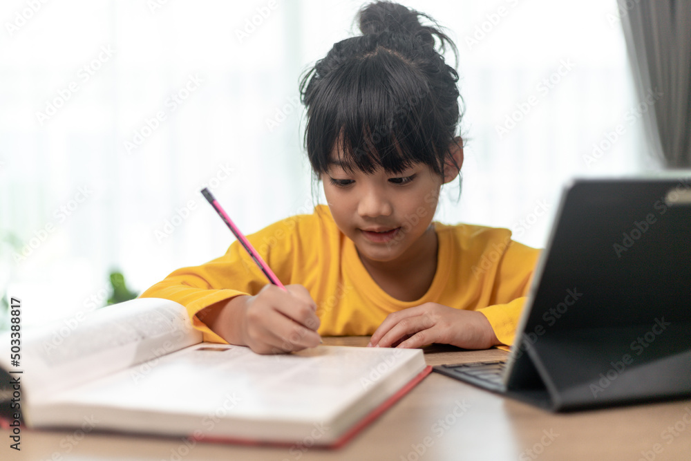 Asian little girl taking class on line and happy for Homeschool Quarantine coranavirus pandemic concept Asian little girl taking class on line and happy for Homeschool Quarantine coranavirus pandemic concept