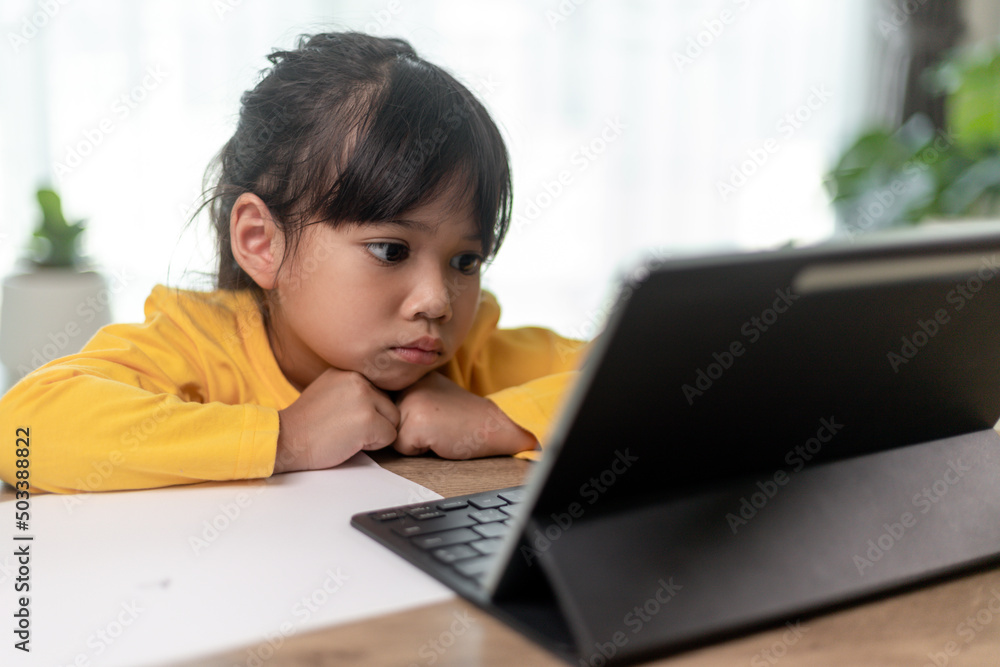 Asian little girl taking class on line and happy for Homeschool Quarantine coranavirus pandemic concept Asian little girl taking class on line and happy for Homeschool Quarantine coranavirus pandemic concept
