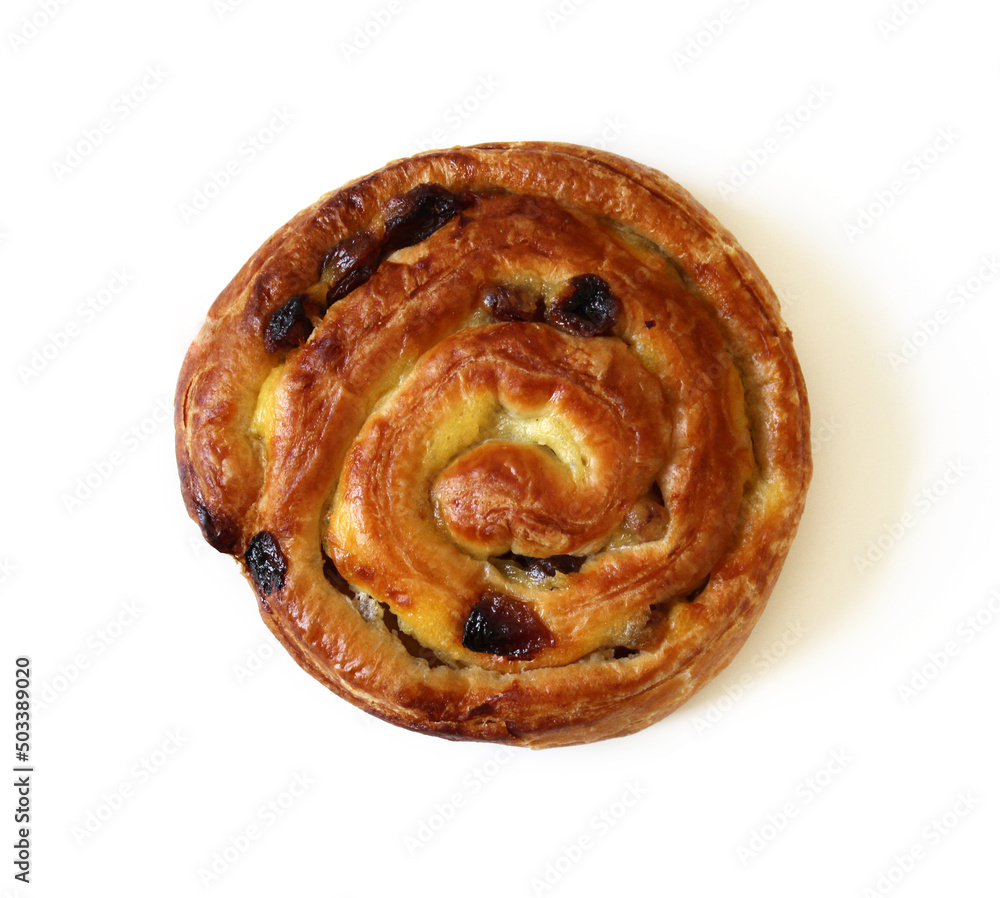 Ruddy spiral bun with raisins isolated on white background.
