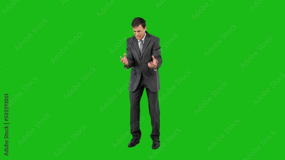 Businessman in suit crying in studio, chroma key Businessman in suit crying in studio, chroma key