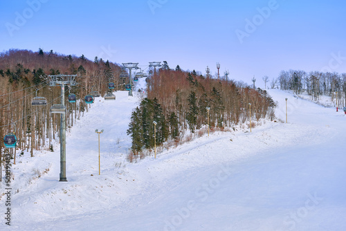 Yuzhno-Sakhalinsk, Russia - Jan 01, 2022: skiers in the slopes of the skiing resort Mountain Air. © rdv27