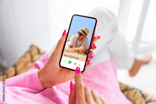 Quadro su tela Woman using online dating app on phone and viewing someone's profile