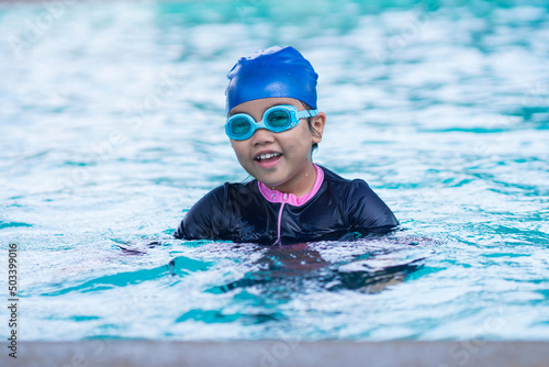 happy children Smiling cute little girl in sunglasses in swimming pool