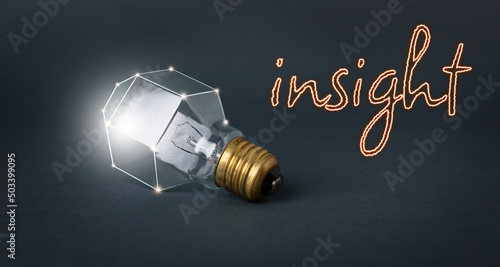 Photos Light bulb and word INSIGHT on dark background