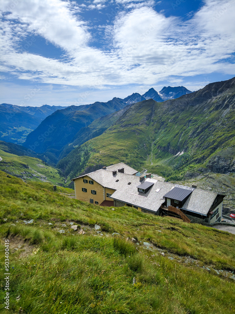 Grossglockner, Austria - August 17, 2019: Grossglockner high alpine road against the blue sky. Beautiful view of the Alpine mountains and the chalet. Vertical