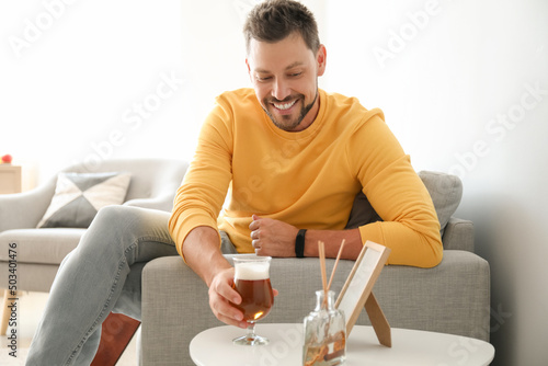 Handsome man drinking beer ...